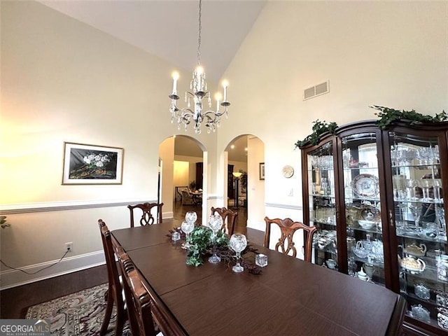 dining room with high vaulted ceiling and an inviting chandelier