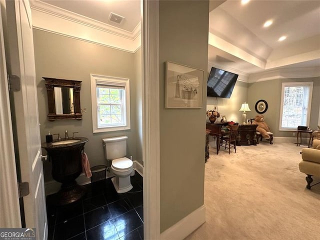 bathroom with tile patterned flooring, vanity, toilet, and crown molding