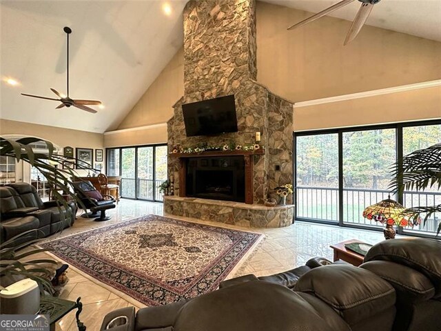 living room featuring a fireplace, high vaulted ceiling, and ceiling fan