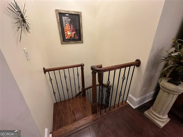 staircase with wood-type flooring