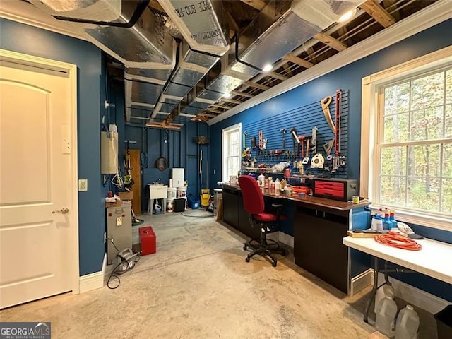 office space featuring a workshop area, sink, and concrete floors