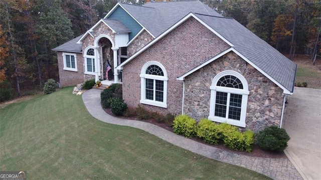 25 Fireside Ct NW, Cartersville, GA 30120 - view of front of property with stone siding, a front lawn, and a wooded view