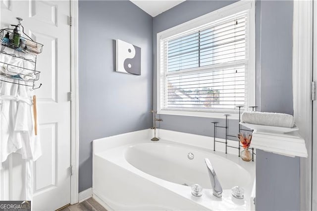 bathroom with a tub to relax in