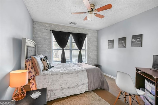 bedroom with carpet flooring, ceiling fan, and a textured ceiling