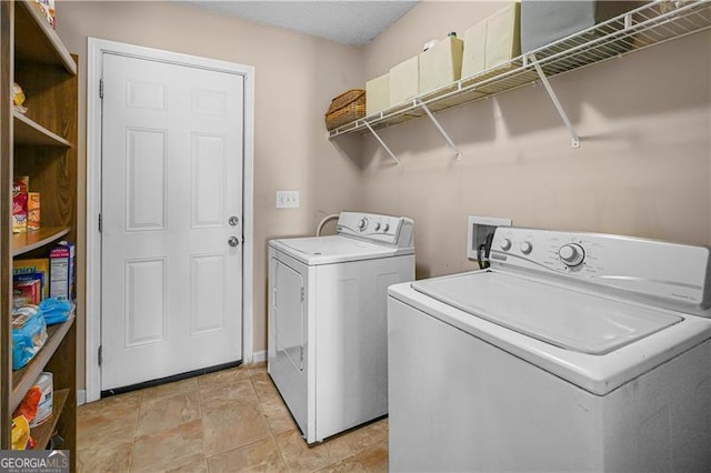 clothes washing area with washing machine and dryer