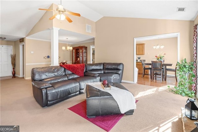 living room with decorative columns, light carpet, ceiling fan with notable chandelier, and vaulted ceiling