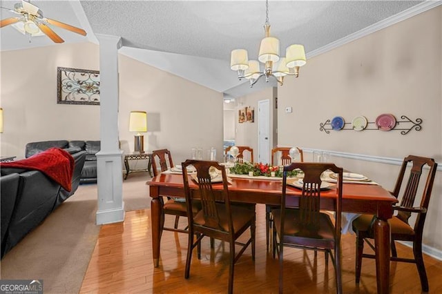 dining area with ceiling fan with notable chandelier, wood-type flooring, ornamental molding, and a textured ceiling