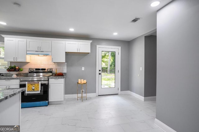 kitchen with white cabinets, stainless steel electric range oven, stone counters, and tasteful backsplash