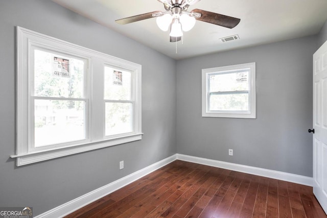 unfurnished room featuring ceiling fan and dark wood-type flooring