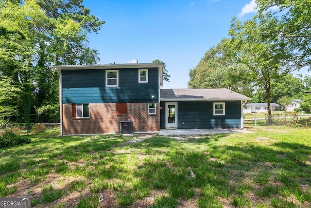 back of house featuring central AC unit, a yard, and a patio