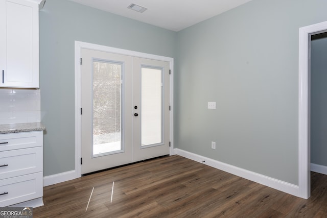 doorway featuring dark hardwood / wood-style floors and french doors