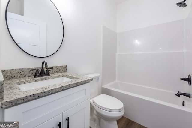 full bathroom featuring bathtub / shower combination, vanity, toilet, and hardwood / wood-style flooring