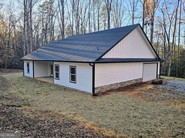 view of home's exterior with a lawn and a garage