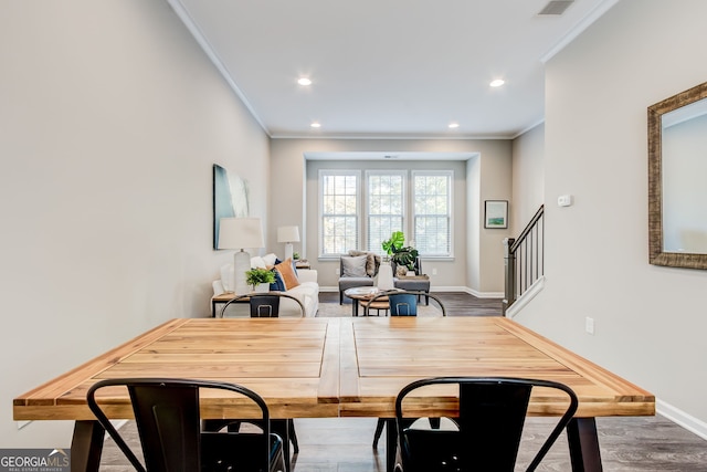 dining room with crown molding and hardwood / wood-style flooring