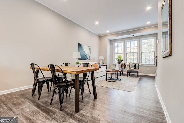 dining room with crown molding and dark hardwood / wood-style flooring