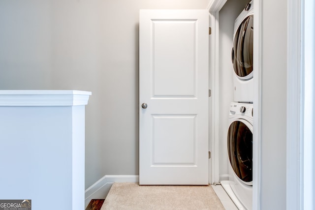 laundry room featuring stacked washer / drying machine