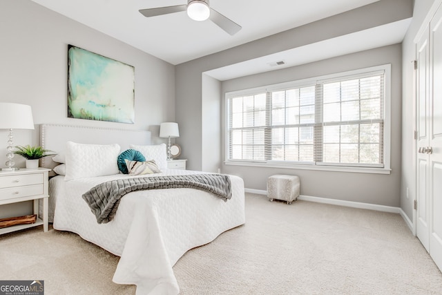 bedroom with ceiling fan and light carpet