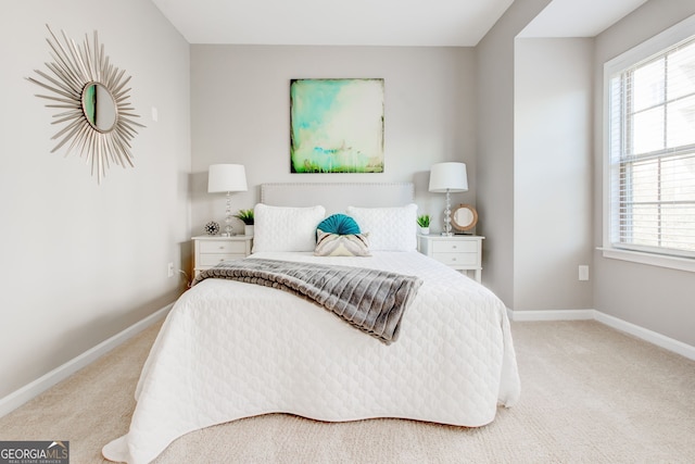 bedroom featuring light colored carpet