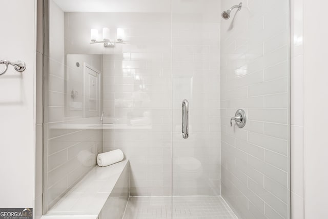 bathroom with a shower with shower door