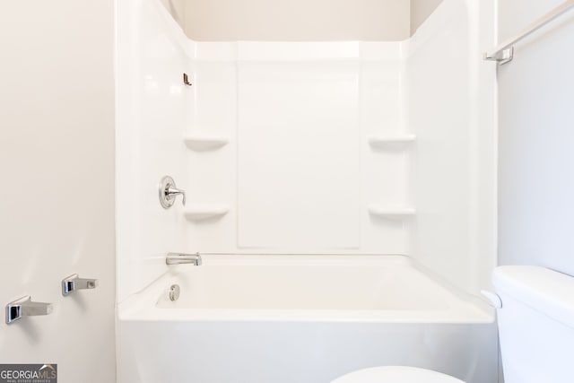 bathroom featuring shower / tub combination and toilet