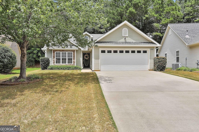 view of front of property featuring cooling unit, a garage, and a front lawn