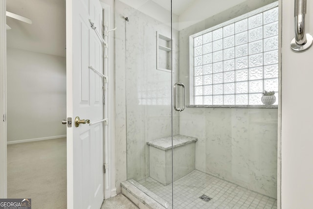 bathroom featuring ceiling fan and a shower with door