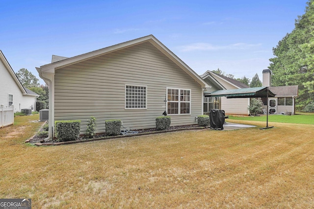 exterior space featuring a lawn and central air condition unit