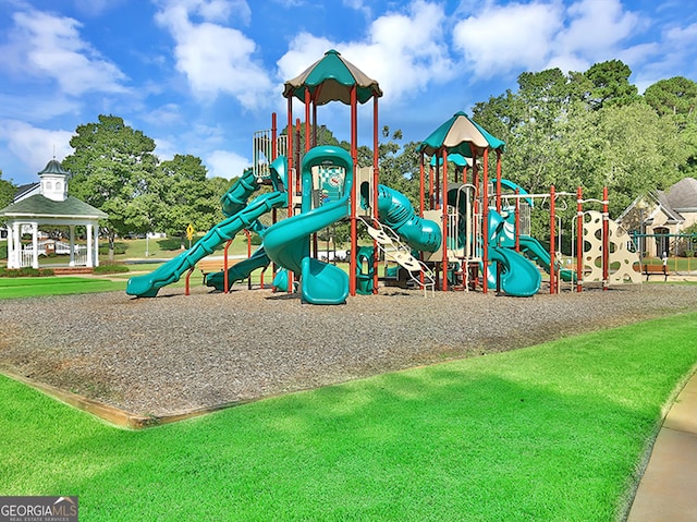 view of playground with a lawn