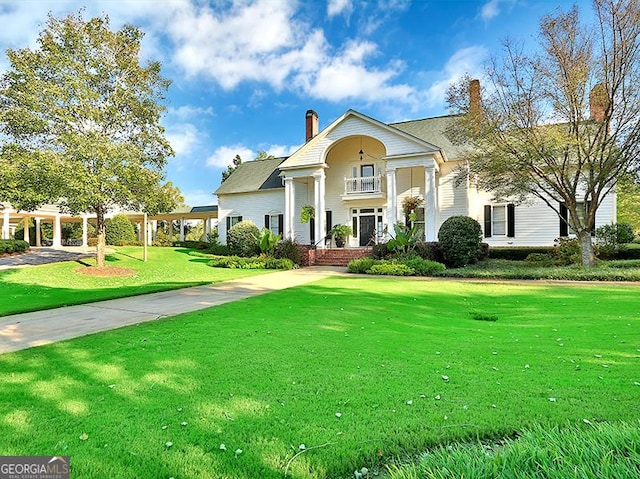 neoclassical / greek revival house with a front yard