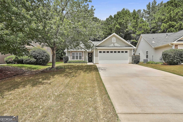 view of front of property with a front lawn, a garage, and cooling unit