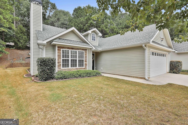 view of front of house featuring a garage and a front yard