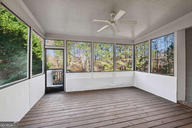 unfurnished sunroom with ceiling fan