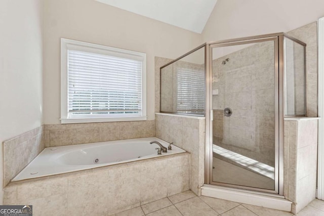 bathroom featuring tile patterned flooring, independent shower and bath, and vaulted ceiling