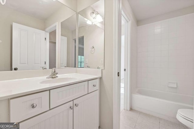 full bathroom with tile patterned floors, vanity, toilet, and tiled shower / bath combo