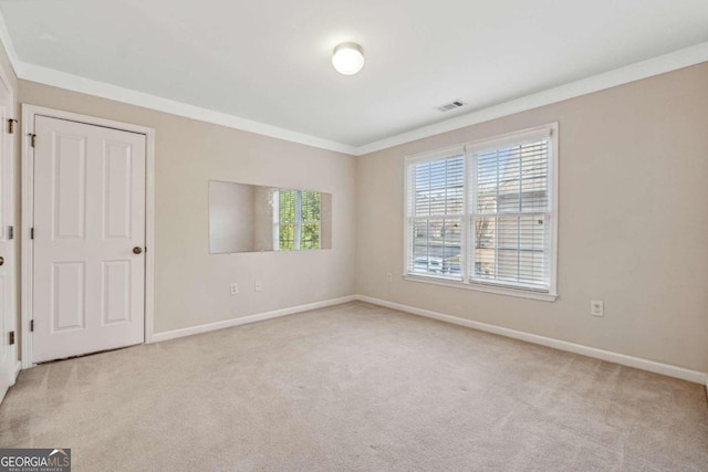 carpeted empty room with crown molding