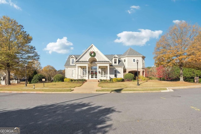 view of front of home featuring a porch and a front yard