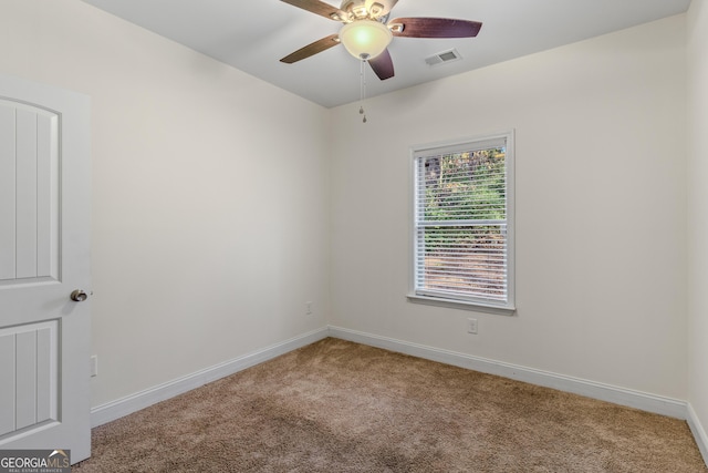 carpeted empty room featuring ceiling fan