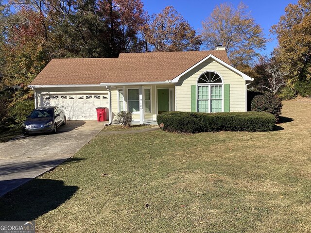 ranch-style home with a front lawn and a garage