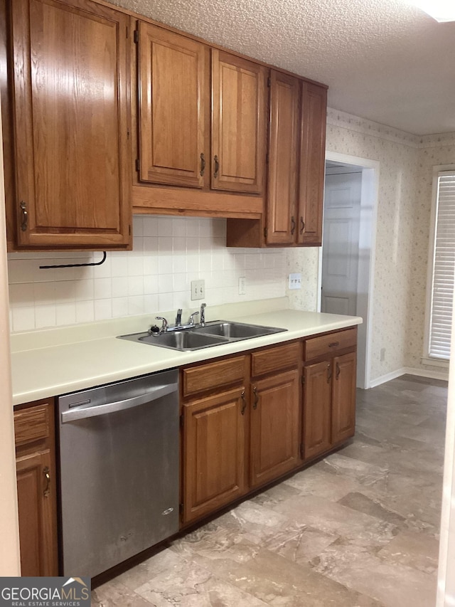 kitchen with sink, backsplash, a textured ceiling, and dishwasher