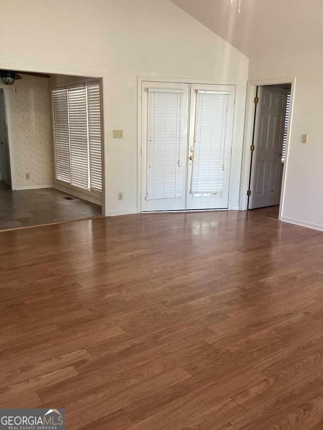 interior space featuring vaulted ceiling and dark hardwood / wood-style flooring