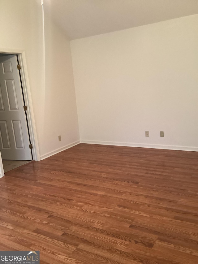 empty room featuring dark hardwood / wood-style flooring