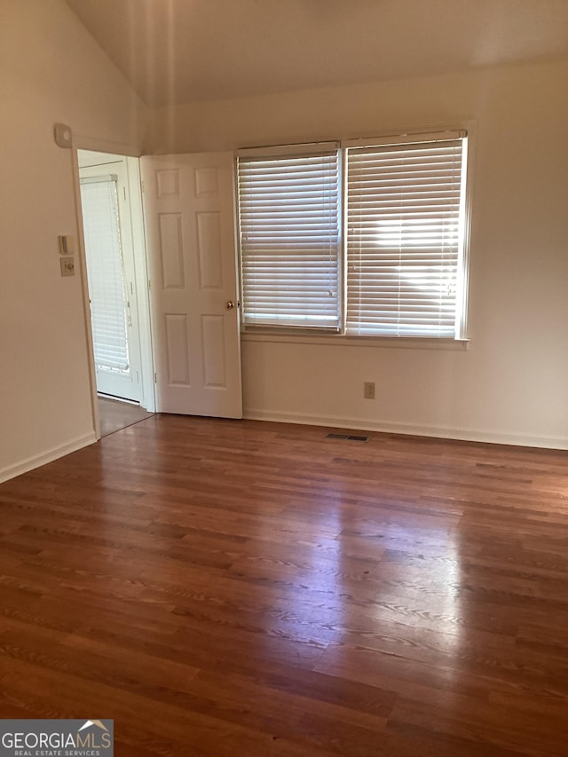 unfurnished room featuring dark hardwood / wood-style flooring