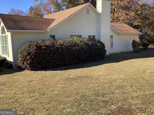 view of home's exterior featuring a lawn