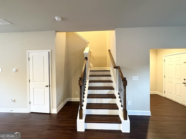 stairway featuring wood-type flooring