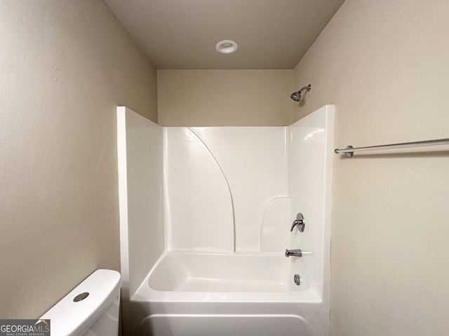 bathroom with shower / bathing tub combination and toilet