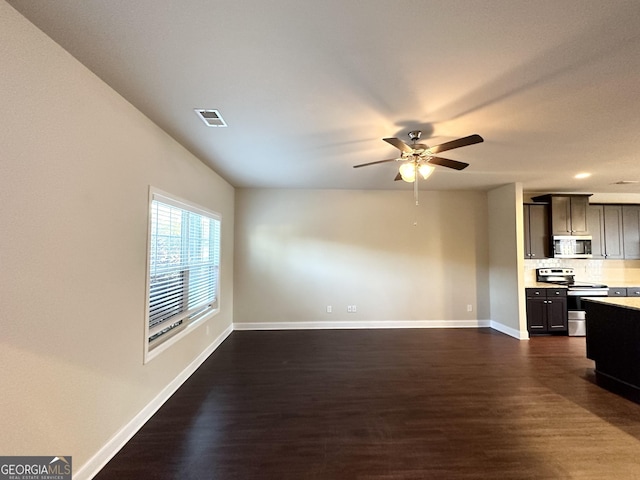 unfurnished living room with ceiling fan and dark hardwood / wood-style flooring