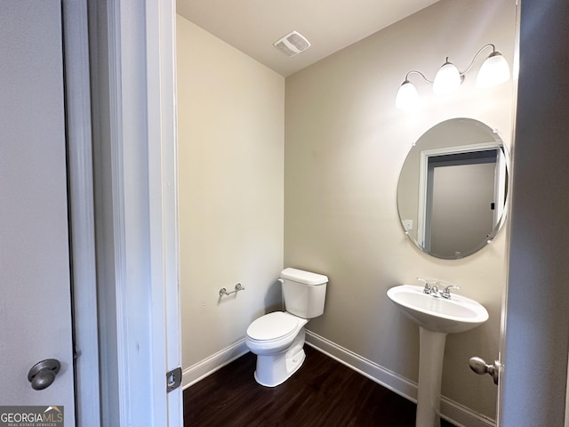 bathroom with sink, hardwood / wood-style floors, and toilet