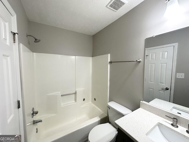 full bathroom featuring bathtub / shower combination, vanity, a textured ceiling, and toilet