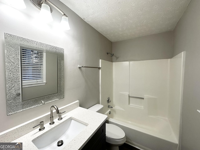 full bathroom with vanity, a textured ceiling, toilet, and tub / shower combination