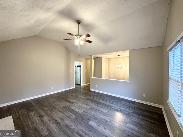 interior space featuring a textured ceiling, dark hardwood / wood-style floors, ceiling fan, and lofted ceiling